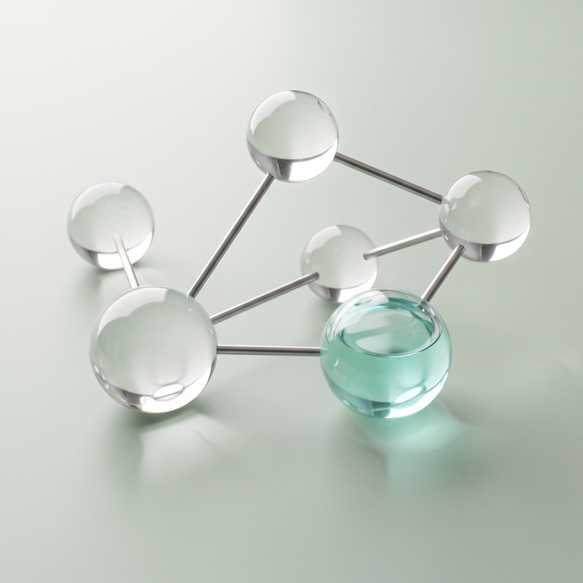 A glass molecule model with one sphere filled with teal liquid